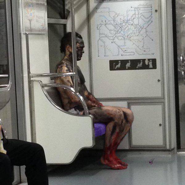 guy sitting on train covered in mud