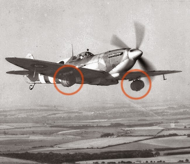 Kegs of beer are attached to a spitfire for the troops in Normandy.