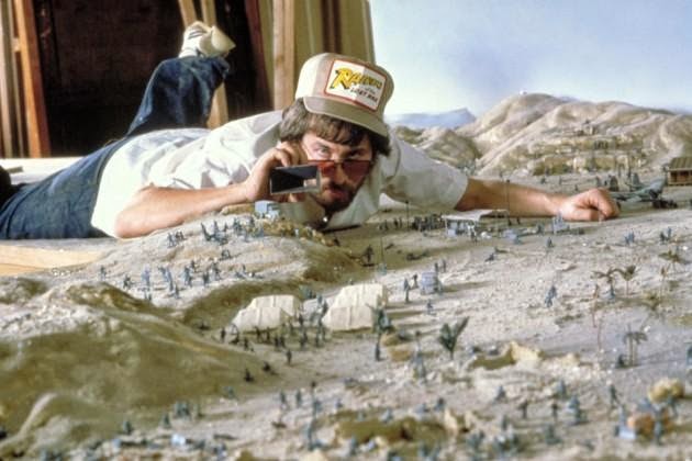 Steven Spielberg takes pictures of miniatures that would feature in Raiders of the Lost Ark.