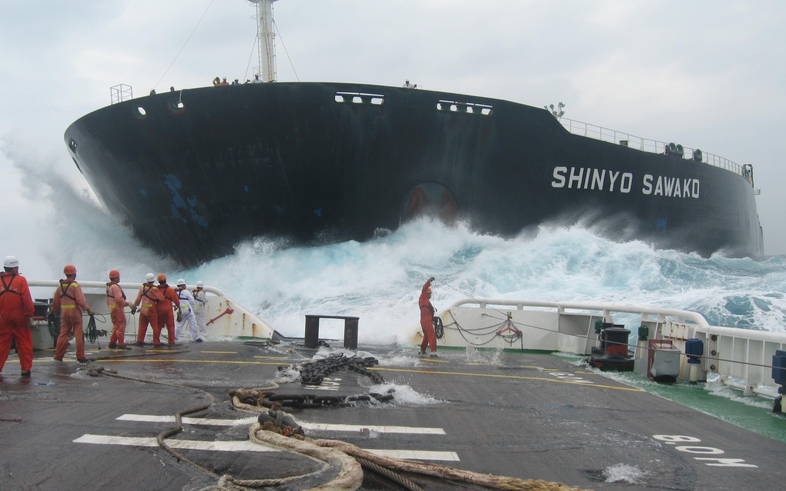 A tugboat approaches Hong Kong freighter, the Shinyo Sawako