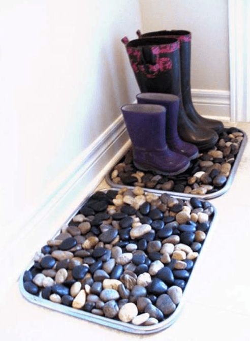 Create a boot drying station

No mom wants wet boots leaking all over her carpet or her freshly mopped floor.  Using a cookie pan and river rocks, you can have a spot just for wet boots by the door.
