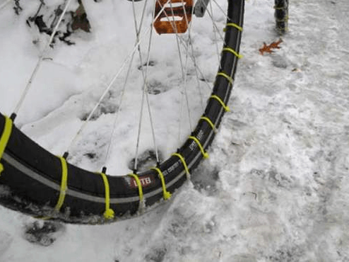 Make your own snow tires

Zip ties make snow tires in a quick minute.  This way, you can keep riding your bike in the snow to work or school, even when the roads and sidewalks are icy and slushy.