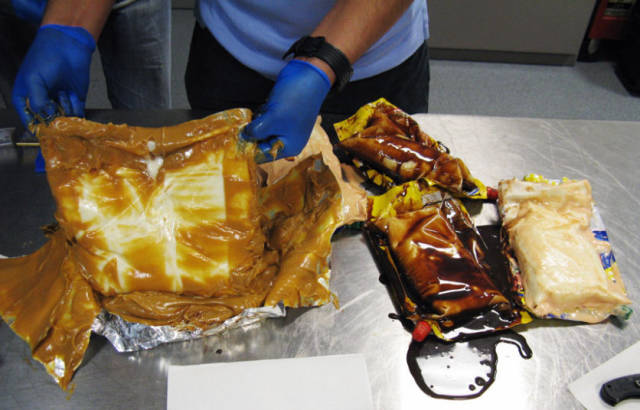 Packets of chocolate syrup and salad dressing concealing cocaine paste in Los Angeles. A mother and daughter traveling from Spain were carrying bags of condiments that customs officials at Los Angeles International Airport decided felt unusually thick. They opened it up to find a plastic bag with cocaine paste placed inside, and then found another syrup packet in their checked-in luggage that contained more cocaine paste. Customs officials said they confiscated more than 10 pounds of the paste, a gummy substance that is extracted from coca leaves and then dried and turned into the white powder sold on the street.