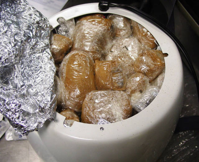 Packets of opium covered in cinnamon hidden inside a rice cooker in Los Angeles. Officials found the rice cooker stuffed with 3 pounds of black opium, which had been coated in cinnamon and wrapped in plastic, being transported by a man arriving at Los Angeles International Airport from Iran. They also found a glass jar with a dark jelly-like substance in a suitcase that turned out to be opium. Officials said the opium had a street value of about $110,000 (approx £72,000)