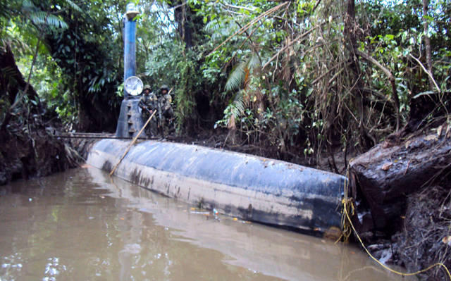 Colombian soldiers stand on top of a seized submarine built by drug smugglers in Timbiqui, Colombia in February 2011. Colombian authorities said the submersible craft was to be used to transport 8 tons of cocaine illegally into Mexico.