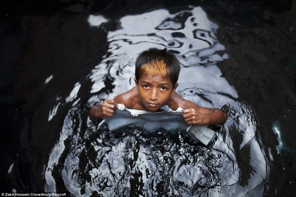 Miraj, 11, works away at a tannery in Dhaka, Bangladesh: