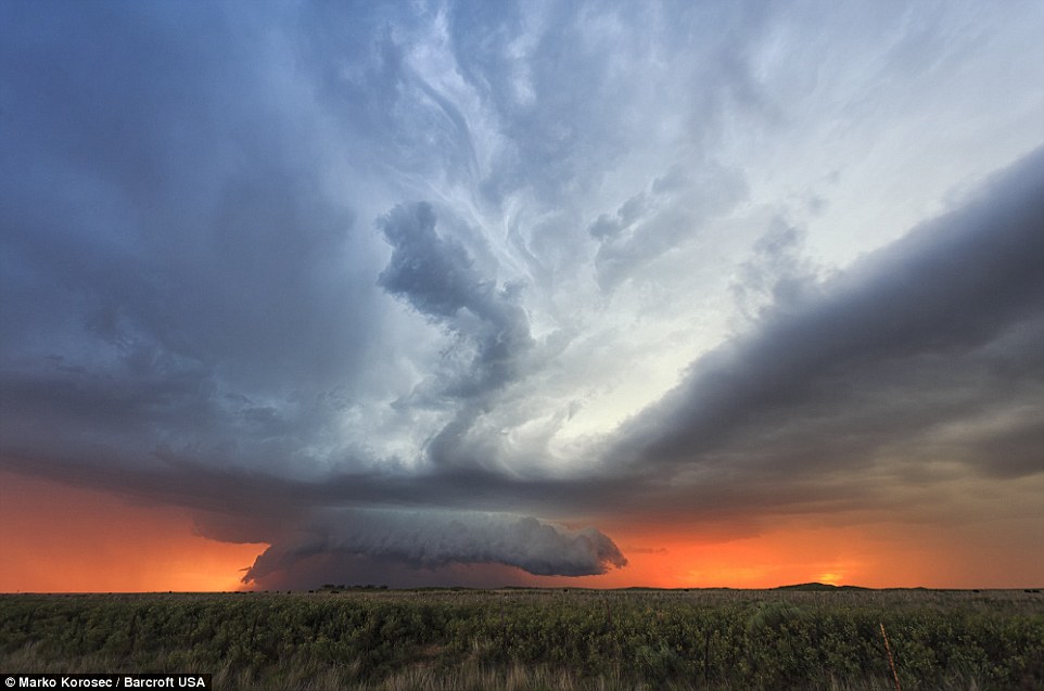 A supercell cloud mushroom forming with a blood orange sunset in the background is captured in Bledsoe, Texas: