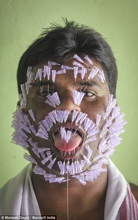 Bhupen Chandra Das, from Assam, India, attempts to break the world record for the most number of needles inserted in a human face: