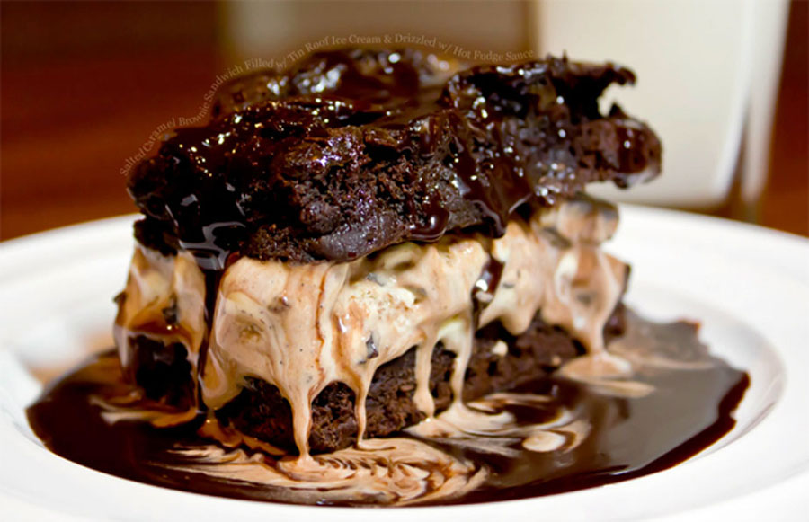 Salted Caramel Brownie Sandwich Filled with Tin Roof Ice Cream and Drizzled with Hot Fudge