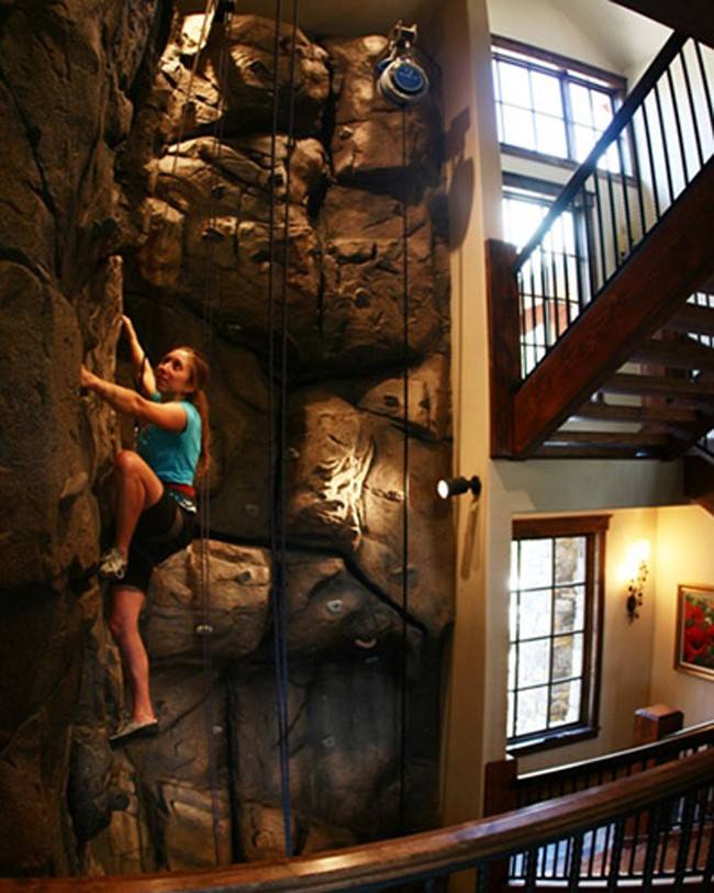 A three-story climbing wall built into the stairwell
