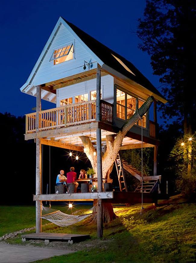 A huge backyard treehouse with patio and balcony