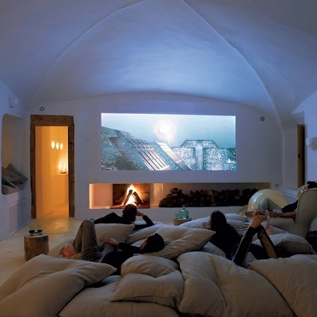 An entire room dedicated to sleepovers with a fireplace and 50" projection screen