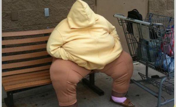 Overweight person wearing a huge yellow hoodie outside a Walmart