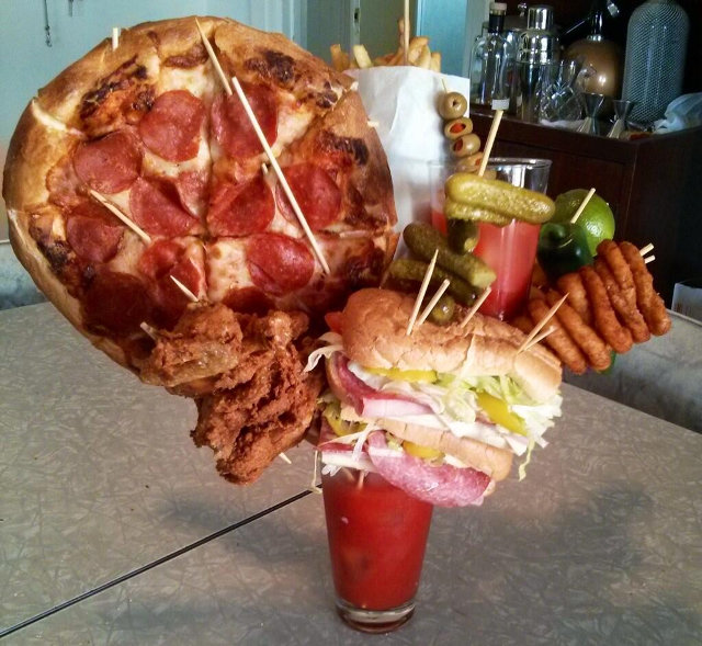 A Bloody Mary garnished with a pizza, wings, a sandwich....and another Bloody Mary. Do want.