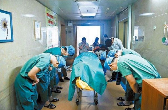 Chinese doctors bow to a boy who had brain cancer, but saved several lives through organ donations.
