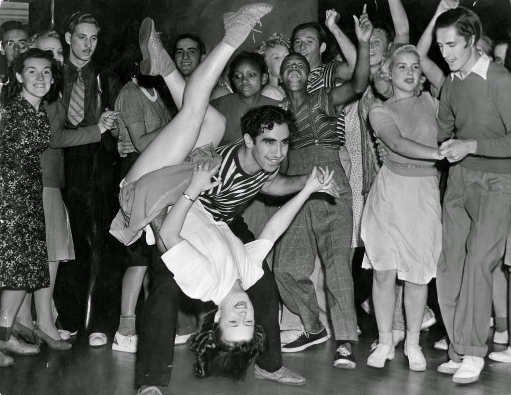 Young couple swing dancing in the 1940s.
