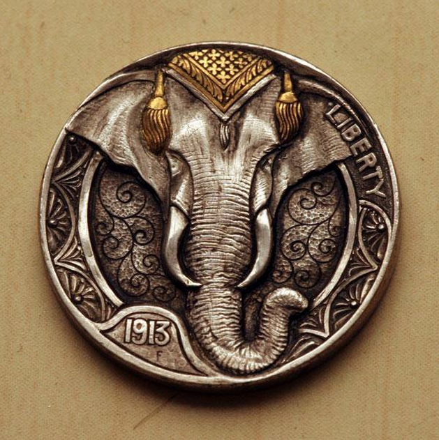 An old nickel carved into something beautiful.