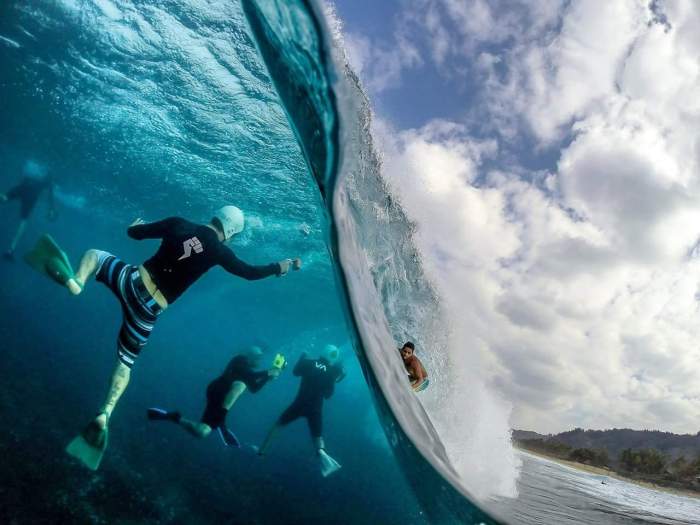 Surf photographers inside a wave.
