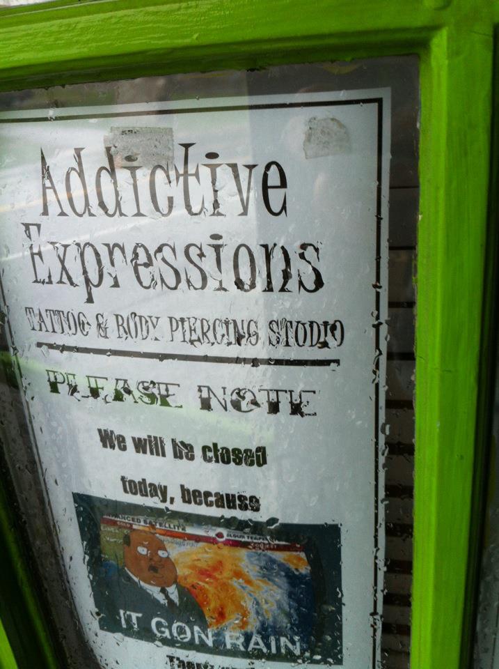 'IT GON RAIN!' closing sign for tattoopiercing shop Addictive Expression during Hurricane Sandy in Lancaster PA