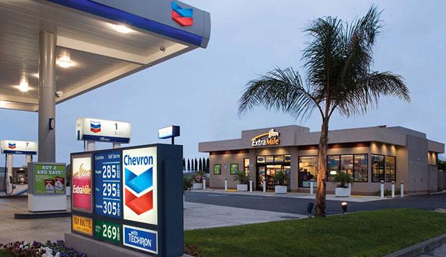 A Chevron gas station next to an Extra Mile
