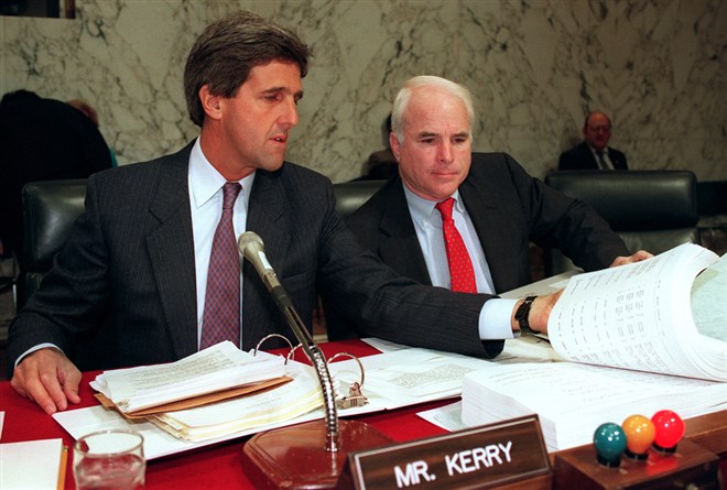Sen. John Kerry, a fellow Vietnam veteran, and Sen. McCain examine a book on June 24, 1992 containing the names of the "total unaccounted for "soldiers who served in the Vietnam War. McCain was first elected to the Senate in 1983, after retiring from the Navy in 1981.
