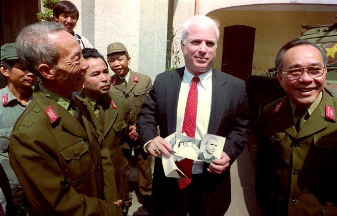 McCain holds photos of himself as a 30-year-old  P.O.W. outside the Army Museum in Hanoi on Oct. 19, 1992. McCain served as a member of the Senate Select Committee on servicemen listed as missing in action (MIAs) in Southeast Asia. McCain is also known for his work towards restoring diplomatic relations with Vietnam.