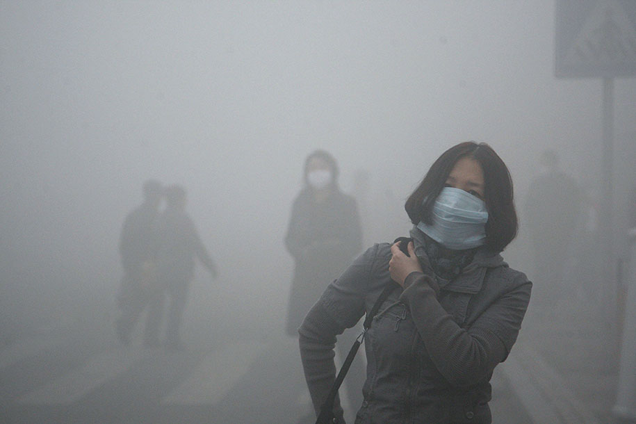 Girl Walks Through Smog In Beijing, Where Small-Particle Pollution Is 40 Times Higher Than International Safety Standards