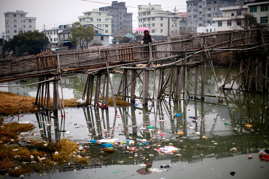 Woman Walks On A Bridge Over A Polluted River, Wenzhou, Zhejiang Province