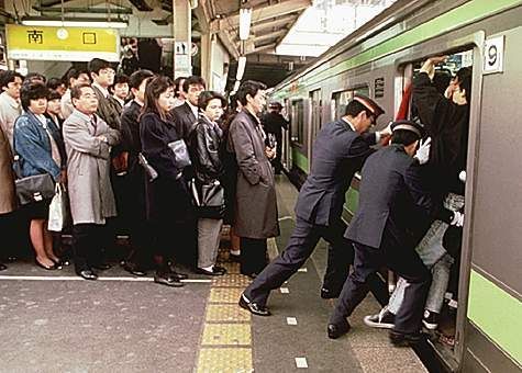 Human "pushers" are hired to work on Tokyo's subway systems to help cram more people into their overcrowded train cars.