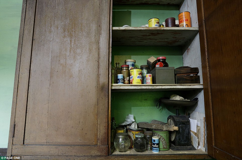 The wooden cupboard in the kitchen suffers from woodworm but still bears groceries bought decades ago, while the old-fashioned scales haven't weighed anything for decades