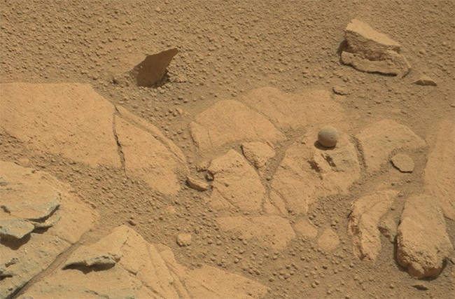 It's kind of amazing how round this rock is, but it's not an alien baseball. It is just a weird, spherical rock.