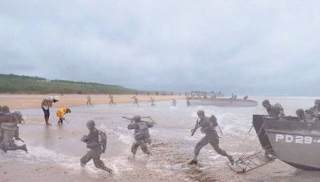 Troops storm Normandy Beach.