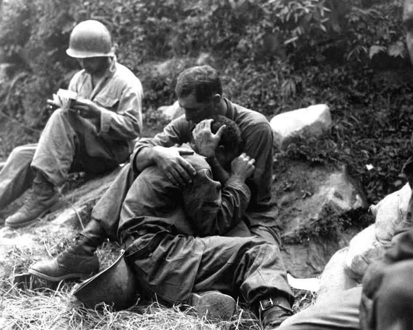 An infantryman is embraced and comforted by a fellow soldier. [Korean War, c. 1950 - 1953]