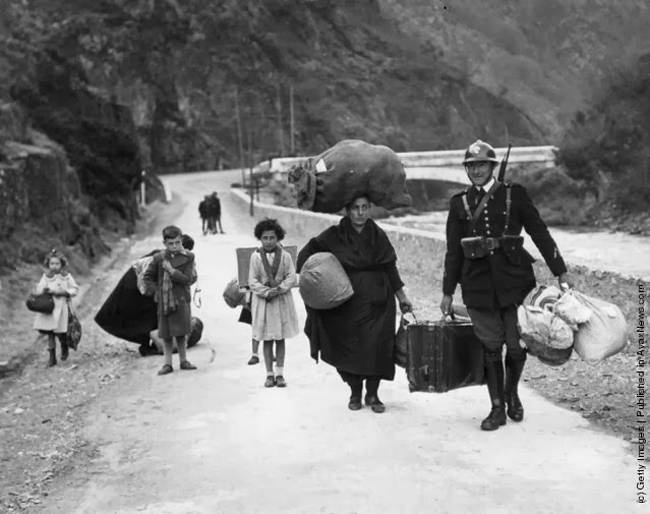 A French soldier helps a family escape during the Spanish Civil War [c. 1938]