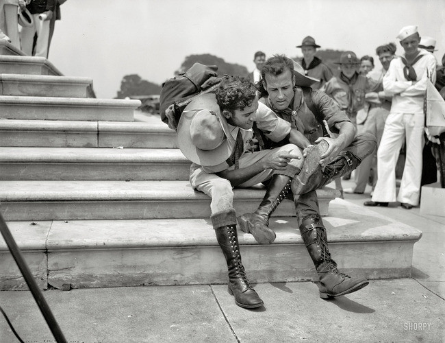 After an 8,000-mile hike to the first Boy Scout Jamboree in 1937, two Scouts examine the soles of their boots.