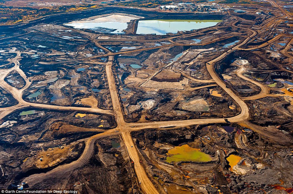 Aerial view of the tar sands region, where mining operations and tailings ponds are so vast they can be seen from outer space; Alberta, Canada.