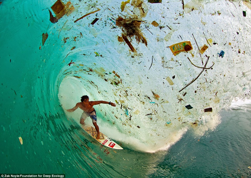 Dede Surinaya catches a wave in a rubbish-covered bay on Java, Indonesia, the world’s most populated island.