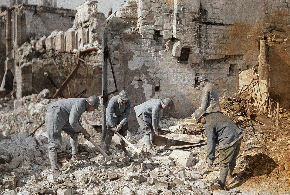 Five French officers clear the rubble from ruins in Reims. 60% of the town was destroyed by Germain artillery and air raids:
