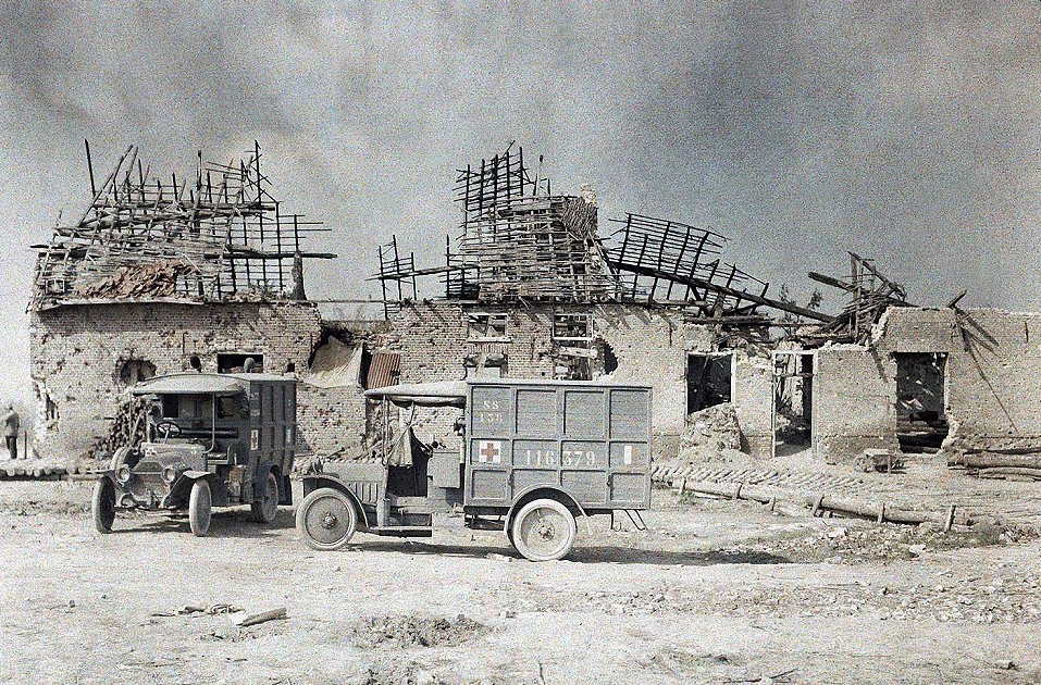 Two ambulance vehicles in front of a building near the village of Boezinge, north of the city of Ypres, that was devastated by artillery fire: