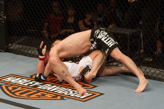Duane Ludwig broke his own ankle here. He pretended it hurt to lull his opponent into a false sense of security. Right after this picture was taken, Duane stood up, and punched his opponent so hard his grandmother's spine straightened. After being declared the winner, he received a "thumbs up" from Master Splinter, his trainer watching from cage side. Ludwig then healed his ankle through sheer will power. While trumpets played, Ludwig rode a pure bred stallion back to the locker room. And yes, his opponents Grandmother thanked Mr. Ludwig for straightening her spine by baking him a lovely apple pie.