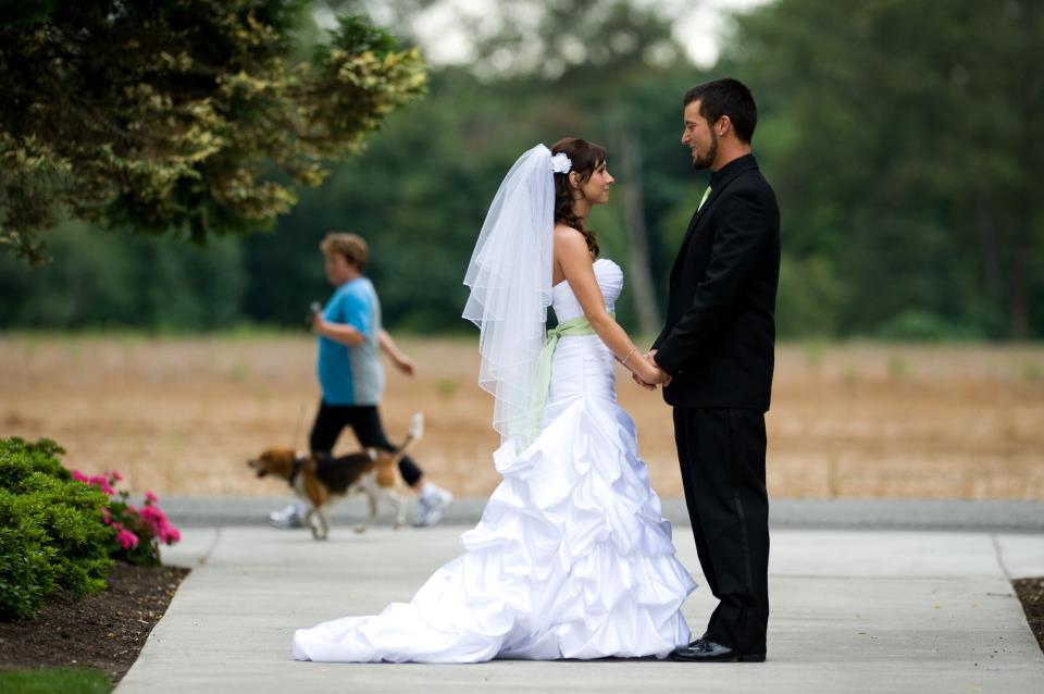 Married couple photobombed by dog walker