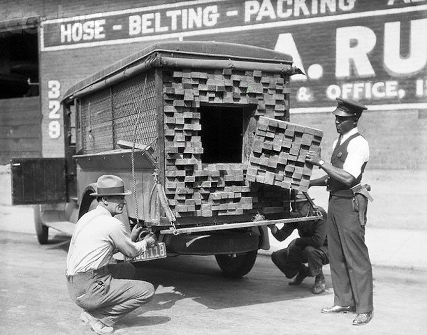 Alerted by the smell of a broken bottle of liquor, Federal Agents inspect a "lumber truck". Los Angeles, 1926