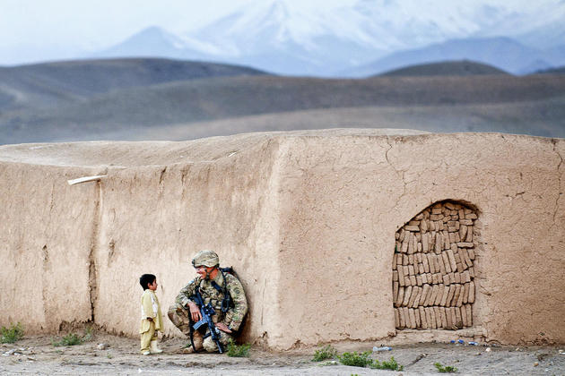sgt. Joshua Smith, a paratrooper with the 82nd Airborne Divisions 1st Brigade Combat Team, chats with an Afghan boy during an Afghan-led clearing operation April 28, 2012, Ghazni province, Afghanistan. The soldier studied the Pashtun language prior to his deployment to southern Ghazni.