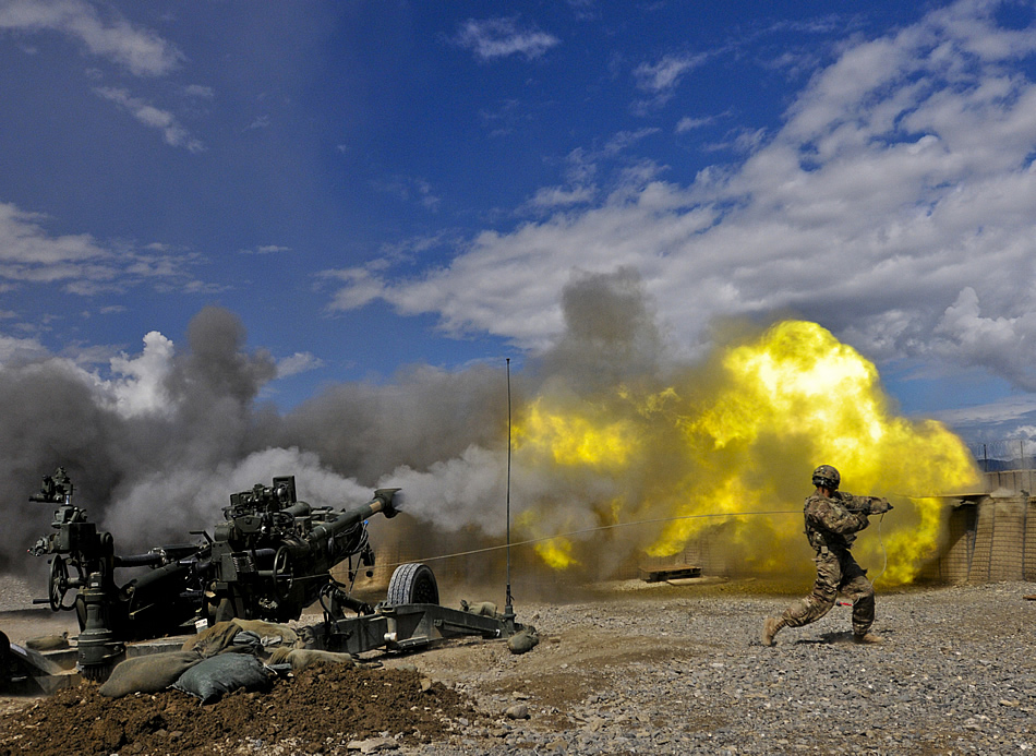 Pfc. Erik Park from San Mateo, Calif., fires his M-777 155mm howitzer. Park, who is in 3rd Platoon, Alpha Battery, 1st Battalion, 77th Field Artillery Regiment, 172nd Infantry Brigade, is the number one man on the five-man numbered team that operates the massive weapon system. He was 12 years old on 911.