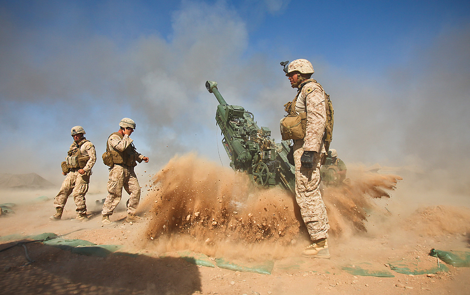 An M777 howitzer kicks rocks and dust into the air after firing during a recent mission.