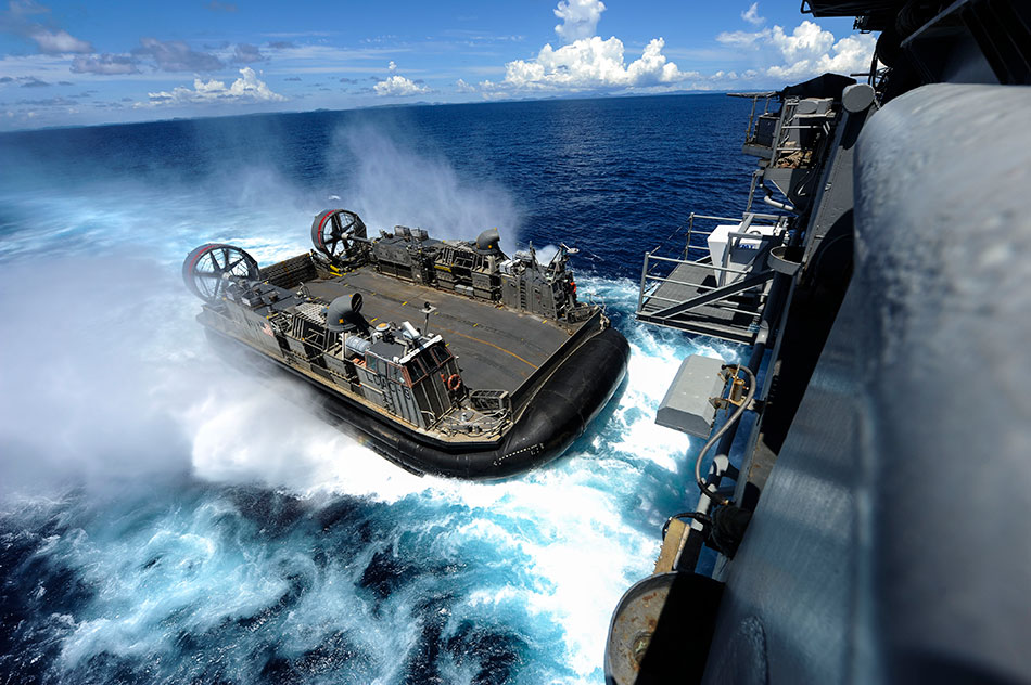 A landing craft air cushion enters the welldeck of the amphibious assault ship USS Bonhomme Richard in the Philippine Sea, Sept. 2nd, 2012.