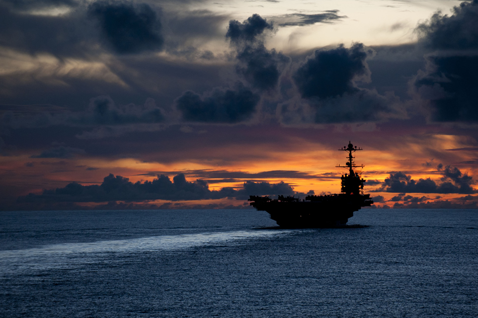 USS Washington with a beautiful sunset as a backdrop.