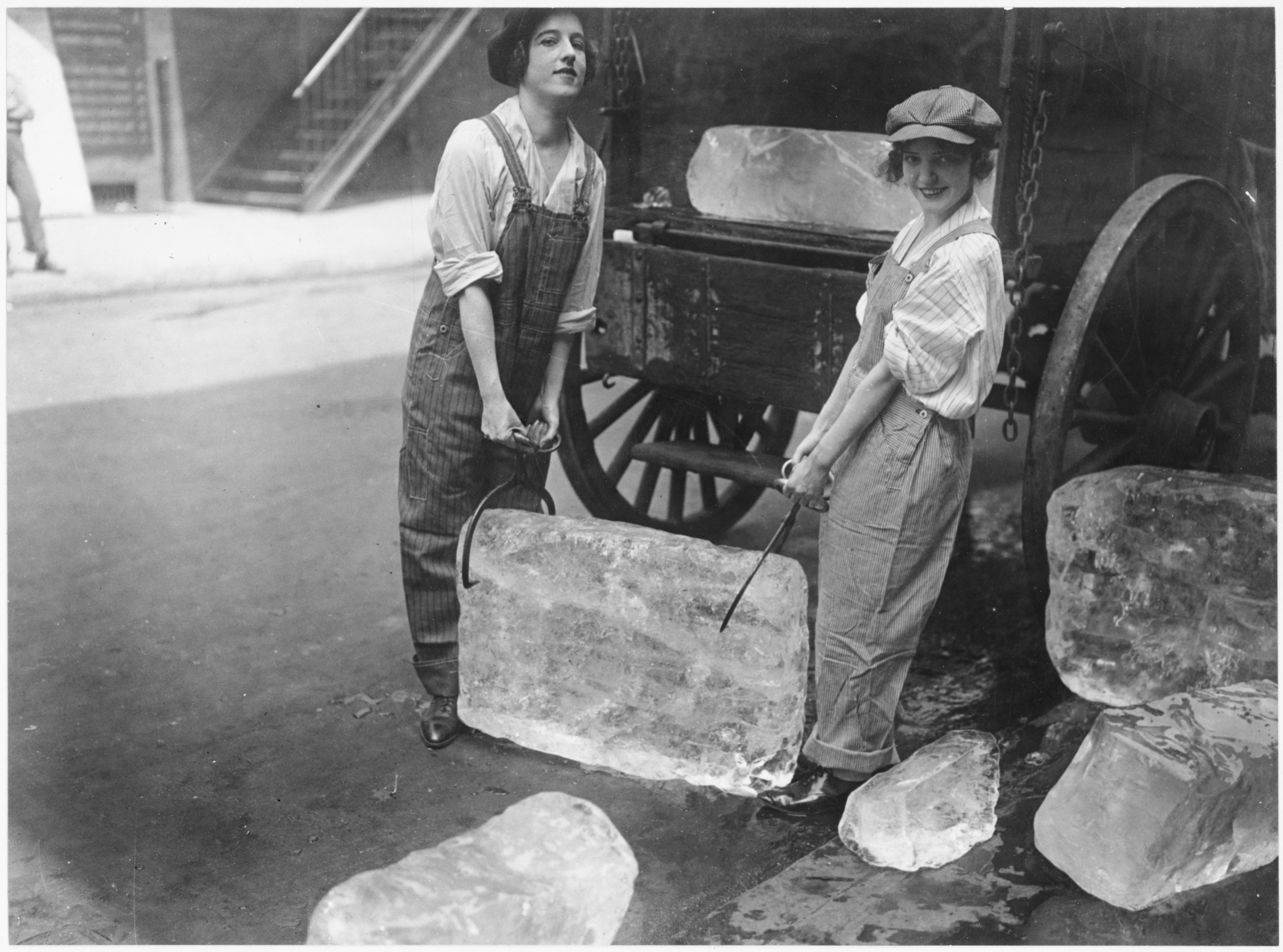 Girls deliver ice. Heavy work that formerly belonged to men began being done by women. The ice girls are delivering ice on a route and their work requires brawn as well as the patriotic ambition to help. 16th of September, 1918