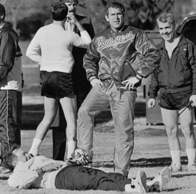 George Bush Jr. has a 'leg up' on his father, President George Bush, as the President attempts to stretch prior to jogging at Fort McNair. The younger Bush, part owner of the Texas Rangers baseball team, was clowning for photographers.