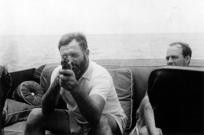 Ernest Hemingway hunting for sharks with a Tommy gun.